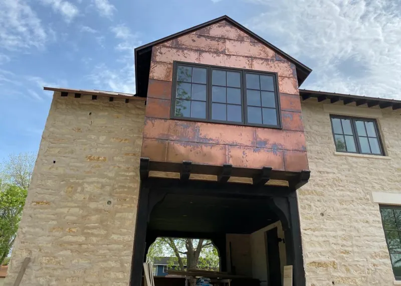 Copper metal panel facade on a stone building for Metal Roof Coating in McCook