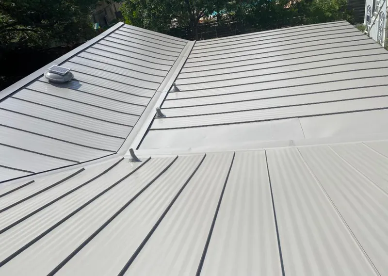 Solar attic fan installed on a metal roof for Roof Ventilation in McCook